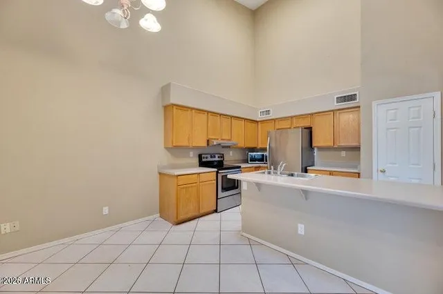 a kitchen with a sink cabinets and window