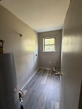 a view of room with window and hardwood floor