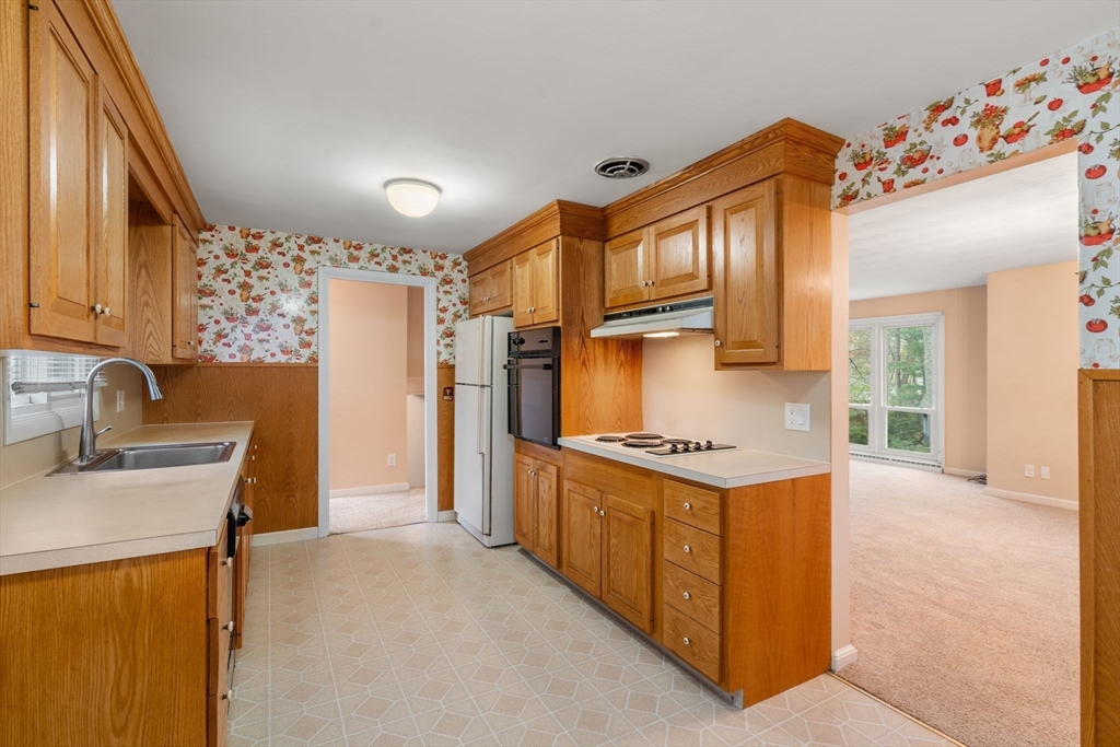 18 Royce Road Framingham, MA 01701 - Photo 7 of 30 a kitchen with stainless steel appliances granite countertop a stove a refrigerator and a sink