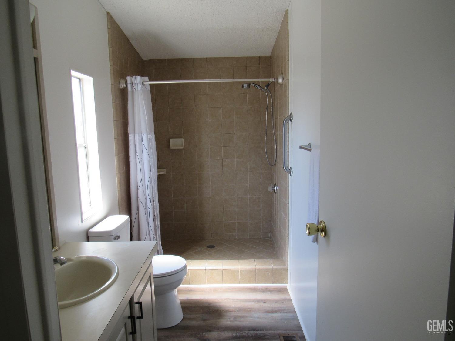 Undisclosed Address Bakersfield, CA 93304 - Photo 11 of 26 a bathroom with a granite countertop bathtub shower sink vanity and toilet