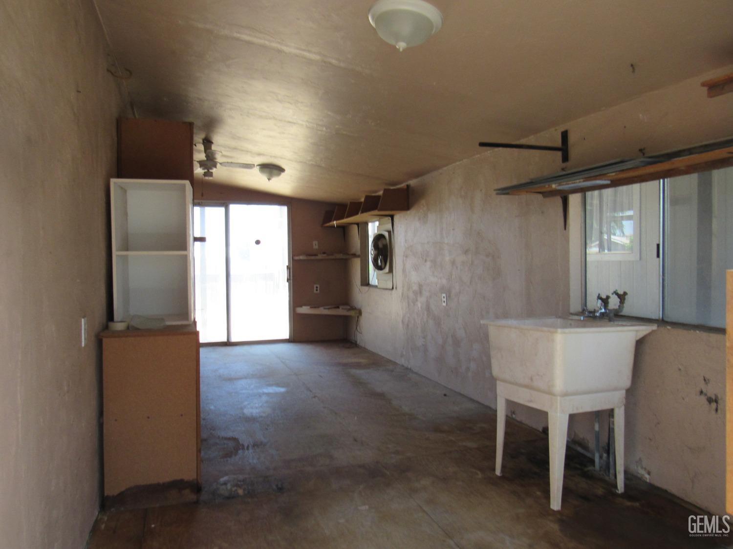 Undisclosed Address Bakersfield, CA 93304 - Photo 18 of 26 a view of a kitchen with furniture and a refrigerator