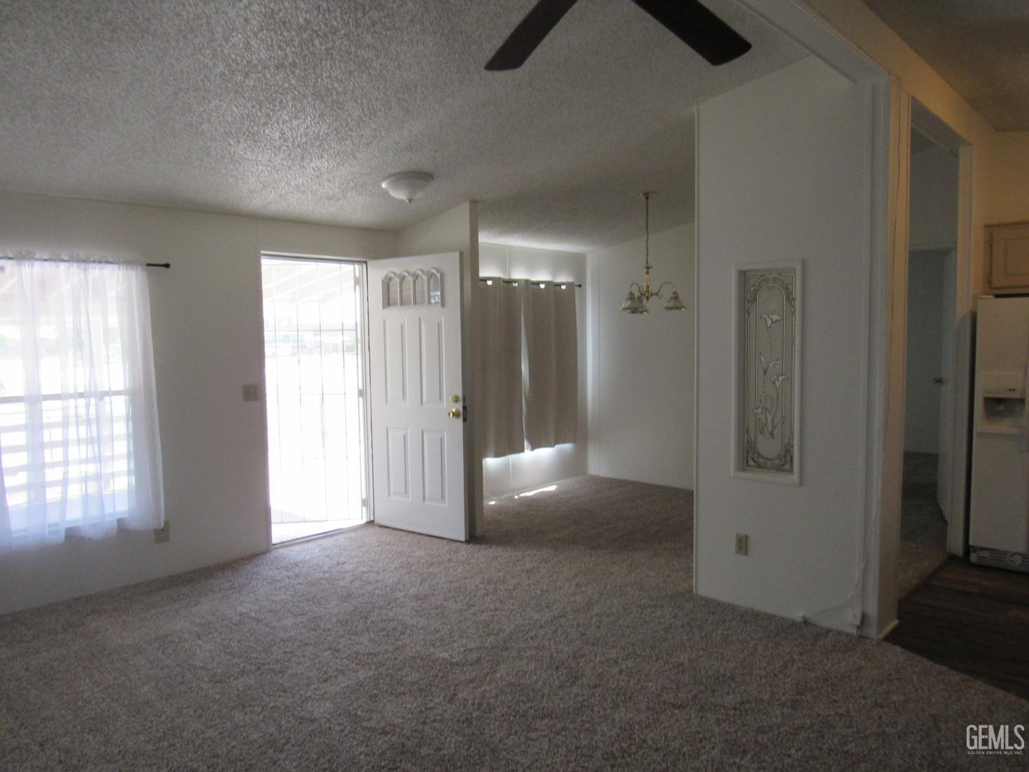 Undisclosed Address Bakersfield, CA 93304 - Photo 2 of 26 an empty room with windows and closet