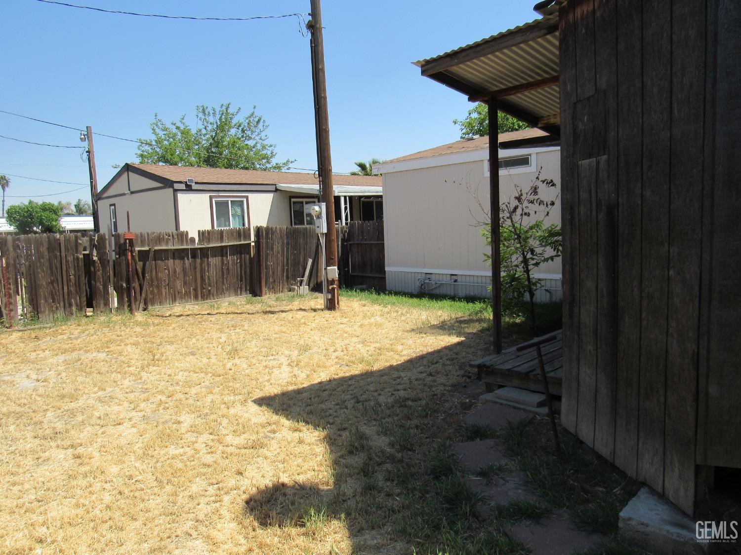 Undisclosed Address Bakersfield, CA 93304 - Photo 23 of 26 a front view of a house with a yard