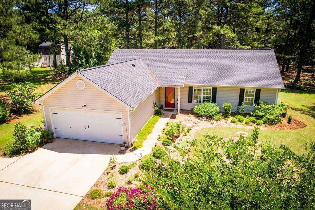 723 South Laney Road Locust Grove, GA 30248 - Photo 1 of 1 a aerial view of a house with a yard and potted plants