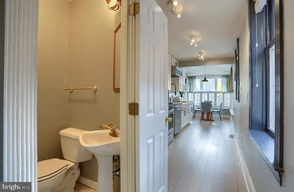 a white toilet sitting next to a bathroom sink