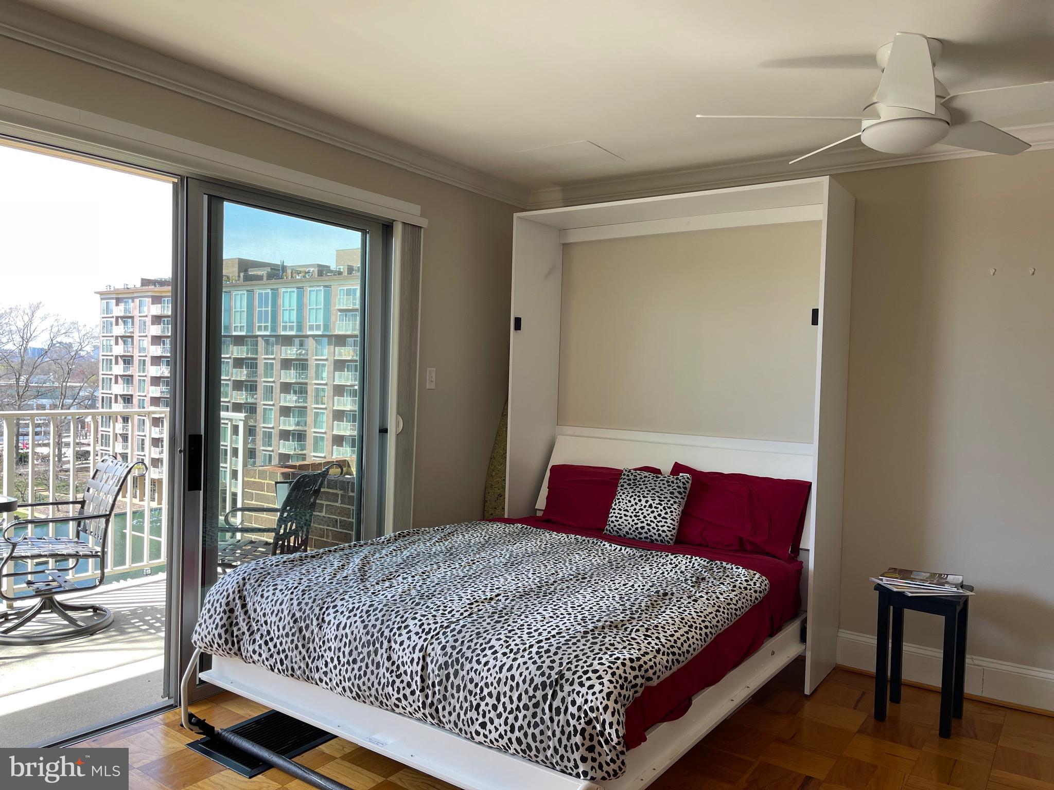 520 N Street Southwest, Unit S618 Washington, DC 20024 - Photo 11 of 62 a bed sitting in a bedroom next to a window