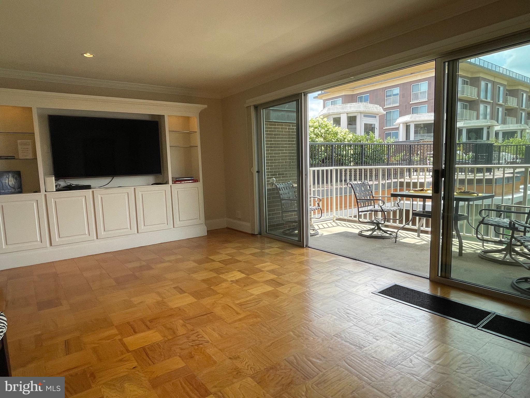 520 N Street Southwest, Unit S618 Washington, DC 20024 - Photo 13 of 62 a view of a livingroom with entryway wooden floor and flat screen tv