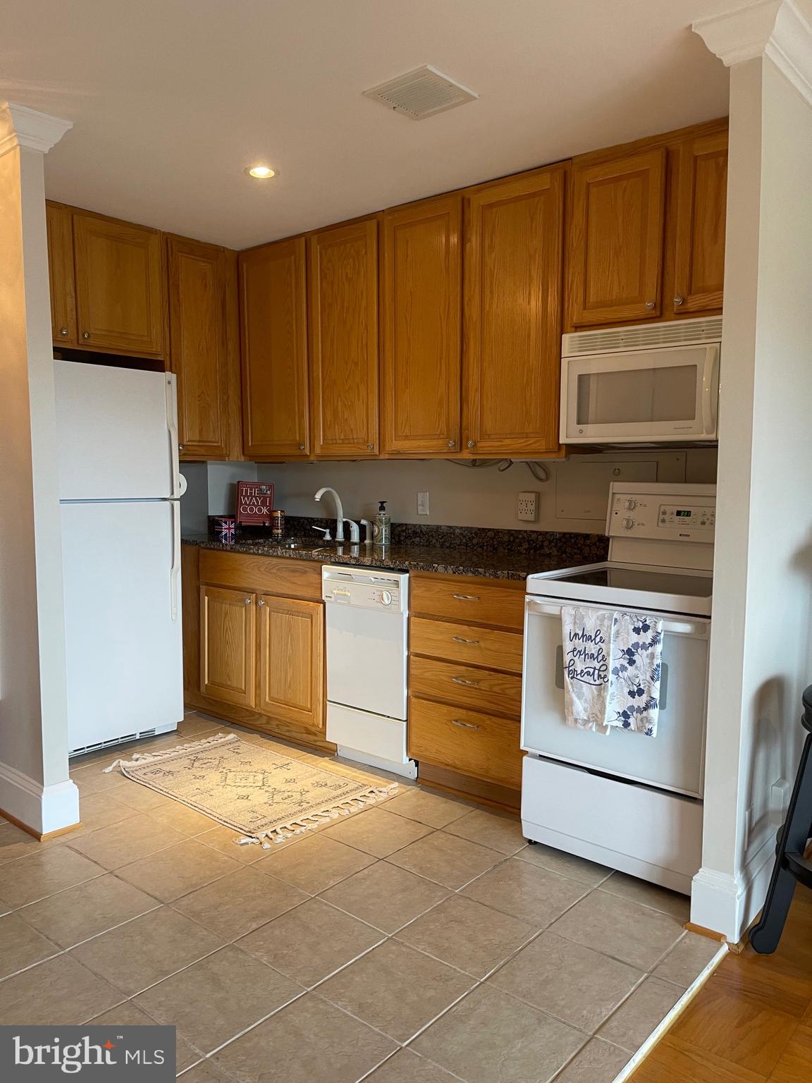 520 N Street Southwest, Unit S618 Washington, DC 20024 - Photo 18 of 62 a kitchen with a cabinets and white appliances