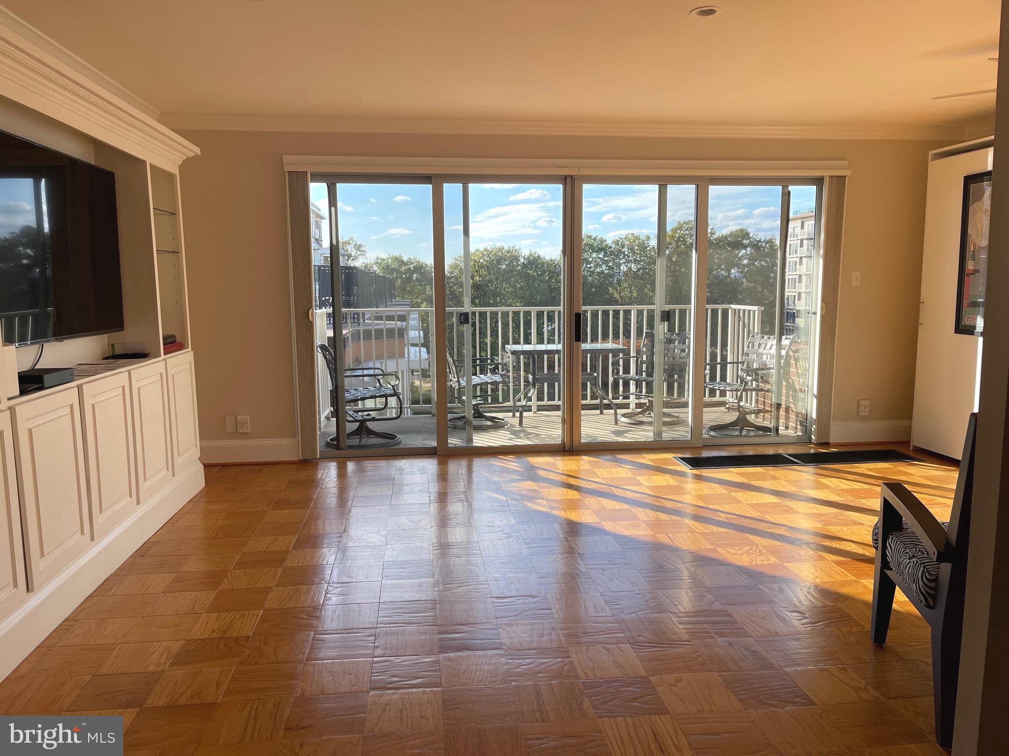 520 N Street Southwest, Unit S618 Washington, DC 20024 - Photo 6 of 62 a view of empty room with wooden floor and floor to ceiling window