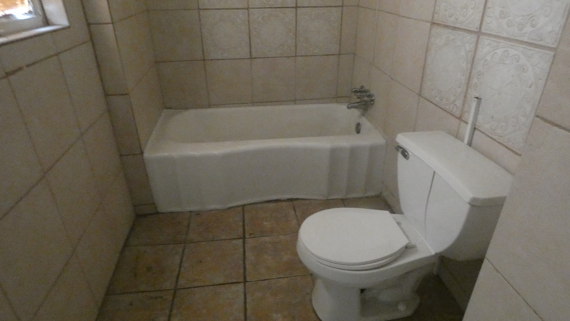 1707 East 83rd Street Chicago, IL 60617 - Photo 5 of 15 a white toilet sitting next to a bath tub