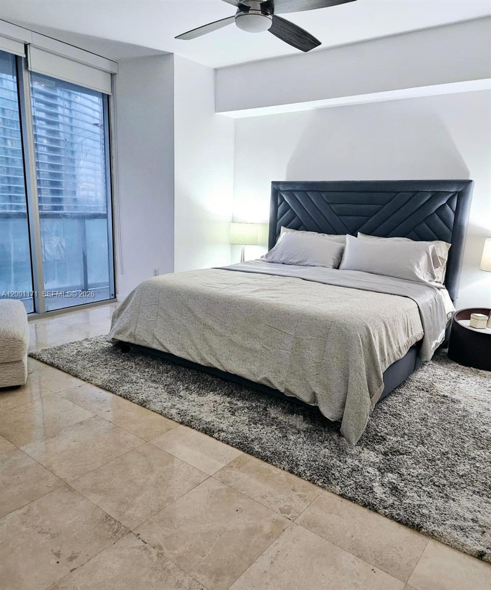 475 Brickell Avenue, Unit 2115 Miami, FL 33131 - Photo 11 of 21 a bedroom with a bed and window
