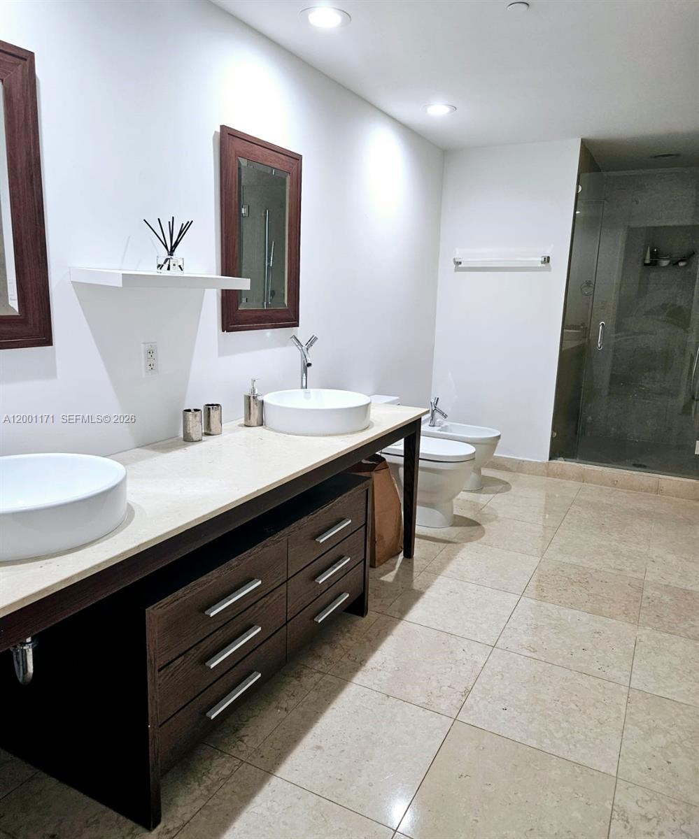 475 Brickell Avenue, Unit 2115 Miami, FL 33131 - Photo 13 of 21 a bathroom with a sink a toilet and mirror
