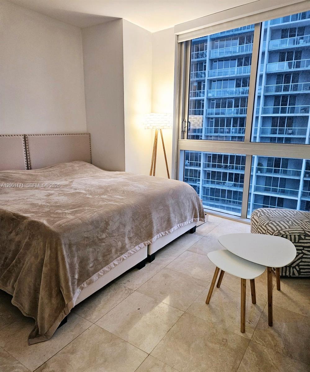 475 Brickell Avenue, Unit 2115 Miami, FL 33131 - Photo 14 of 21 a bedroom with a bed and a table