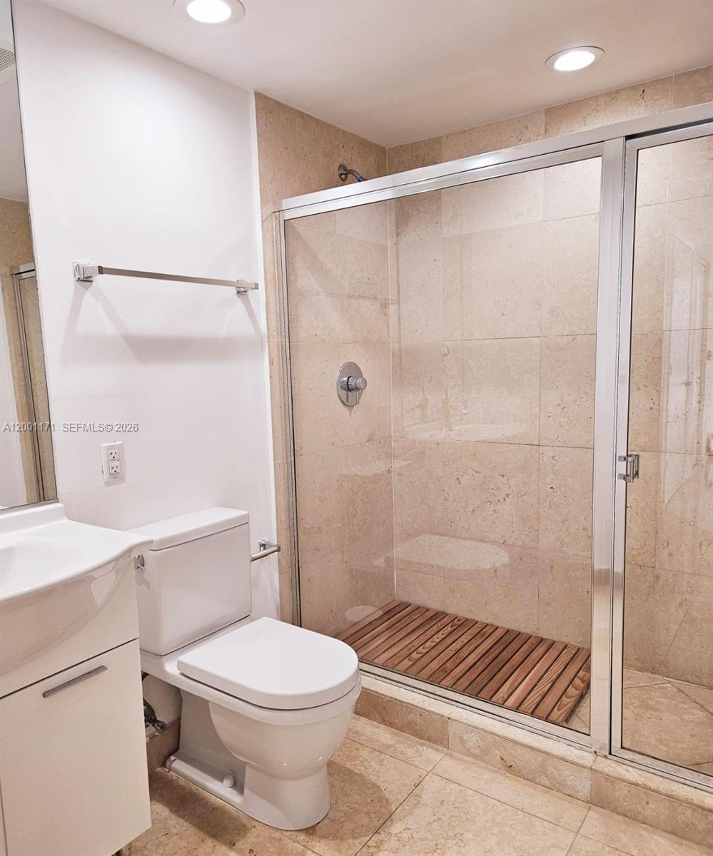 475 Brickell Avenue, Unit 2115 Miami, FL 33131 - Photo 16 of 21 a bathroom with a shower a toilet and a sink