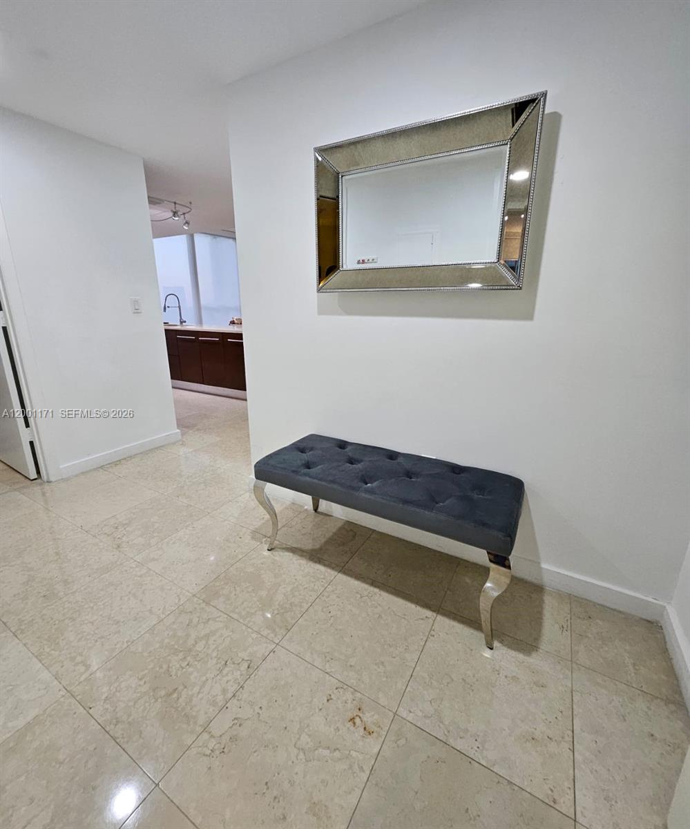 475 Brickell Avenue, Unit 2115 Miami, FL 33131 - Photo 3 of 21 a living room with a couch and a rug