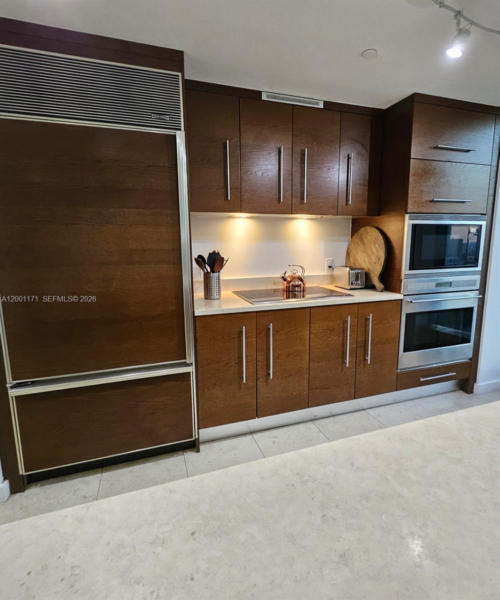 475 Brickell Avenue, Unit 2115 Miami, FL 33131 - Photo 5 of 21 a kitchen with stainless steel appliances granite countertop a refrigerator and a stove