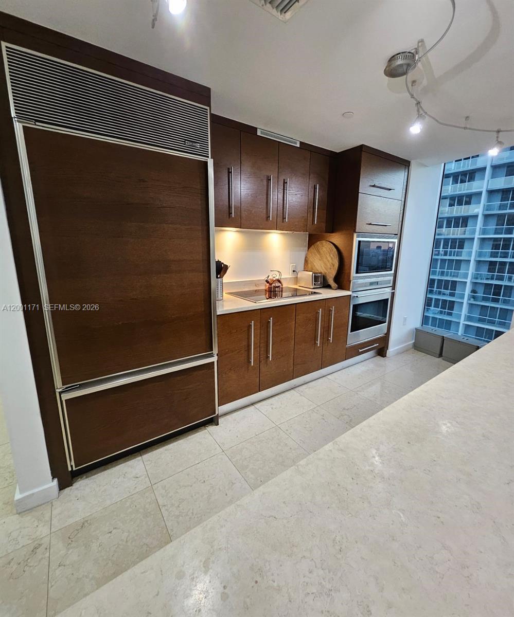 475 Brickell Avenue, Unit 2115 Miami, FL 33131 - Photo 6 of 21 a view of kitchen with refrigerator and cabinets