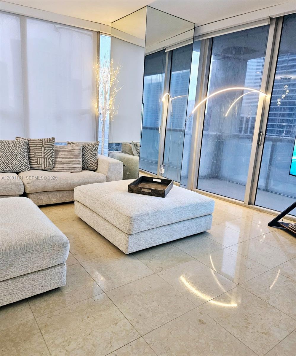 475 Brickell Avenue, Unit 2115 Miami, FL 33131 - Photo 8 of 21 a bedroom with a bed and a couch