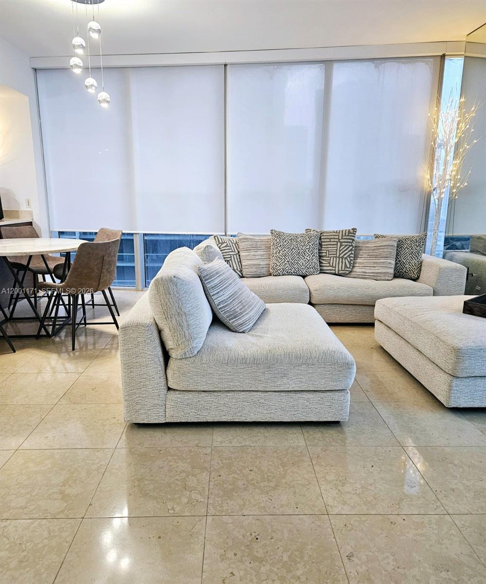 475 Brickell Avenue, Unit 2115 Miami, FL 33131 - Photo 9 of 21 a living room with furniture and a large window