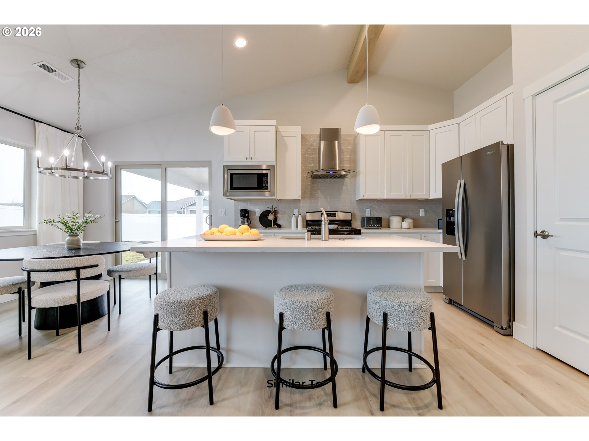 227 Southwest Goldfinch Lane Boardman, OR 97818 - Photo 6 of 28 a kitchen with refrigerator cabinets and dining table