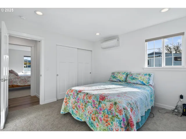 a bedroom with a bed and a painting