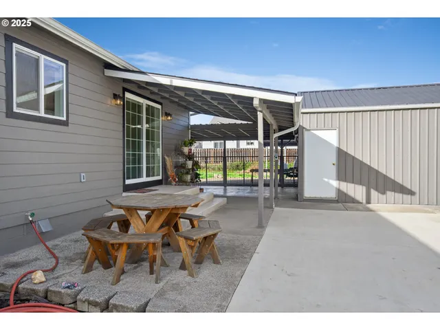 a view of a patio with table and chairs with wooden floor