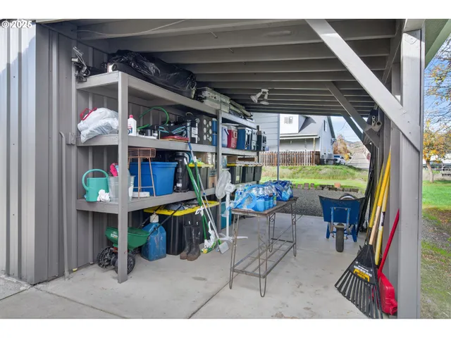 a view of an house with a yard and potted plants