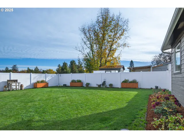 a front view of a house with a garden and yard