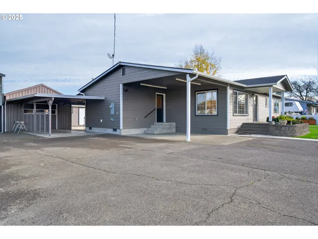 a view of house with outdoor space and parking space