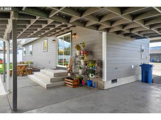a view of a porch with furniture and garden