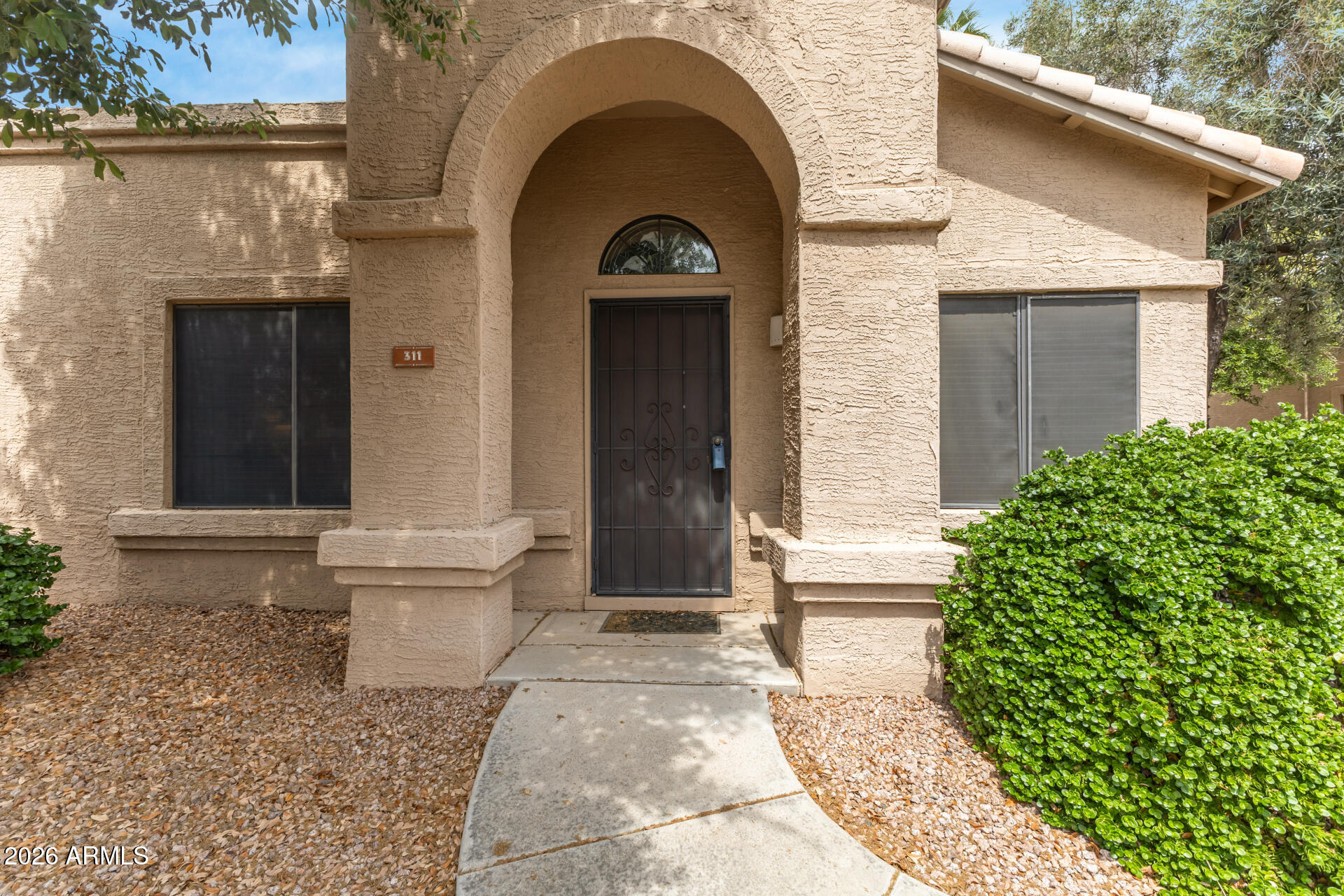 14300 West Bell Road, Unit 311 Surprise, AZ 85374 - Photo 1 of 50 a front view of a house with a garden
