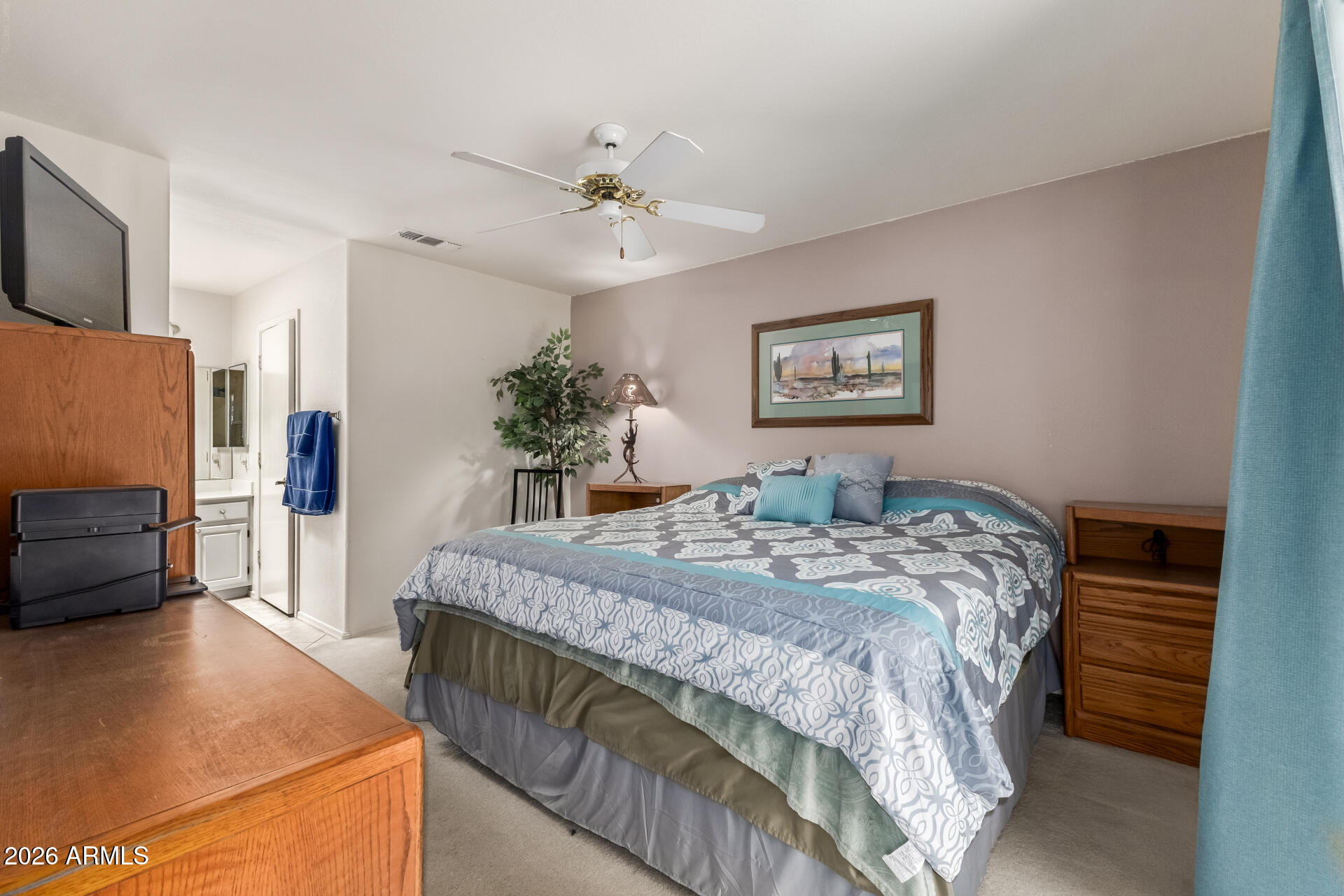 14300 West Bell Road, Unit 311 Surprise, AZ 85374 - Photo 11 of 50 a bed sitting in a spacious bedroom next to a window