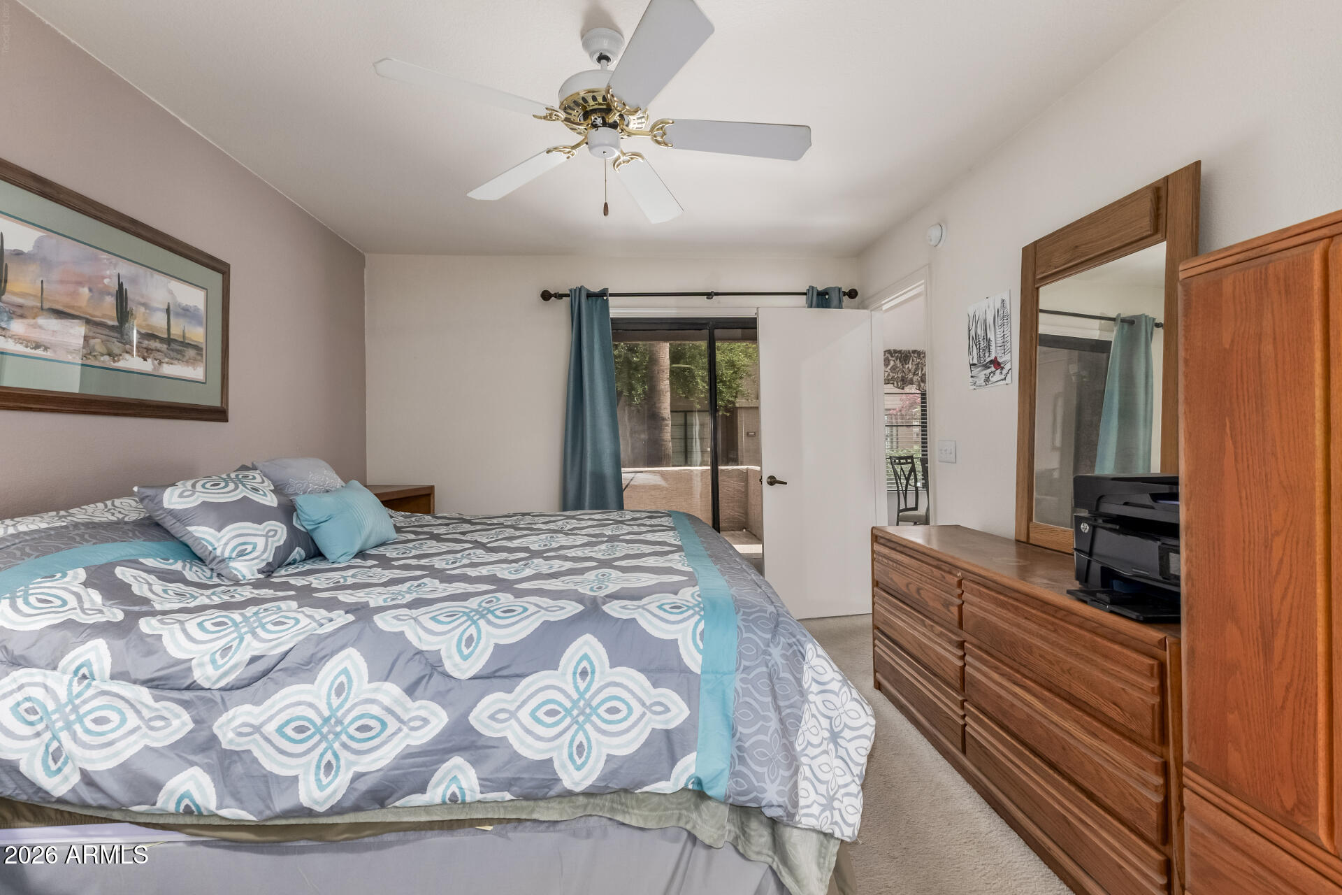 14300 West Bell Road, Unit 311 Surprise, AZ 85374 - Photo 12 of 50 a bedroom with a large bed and a chandelier