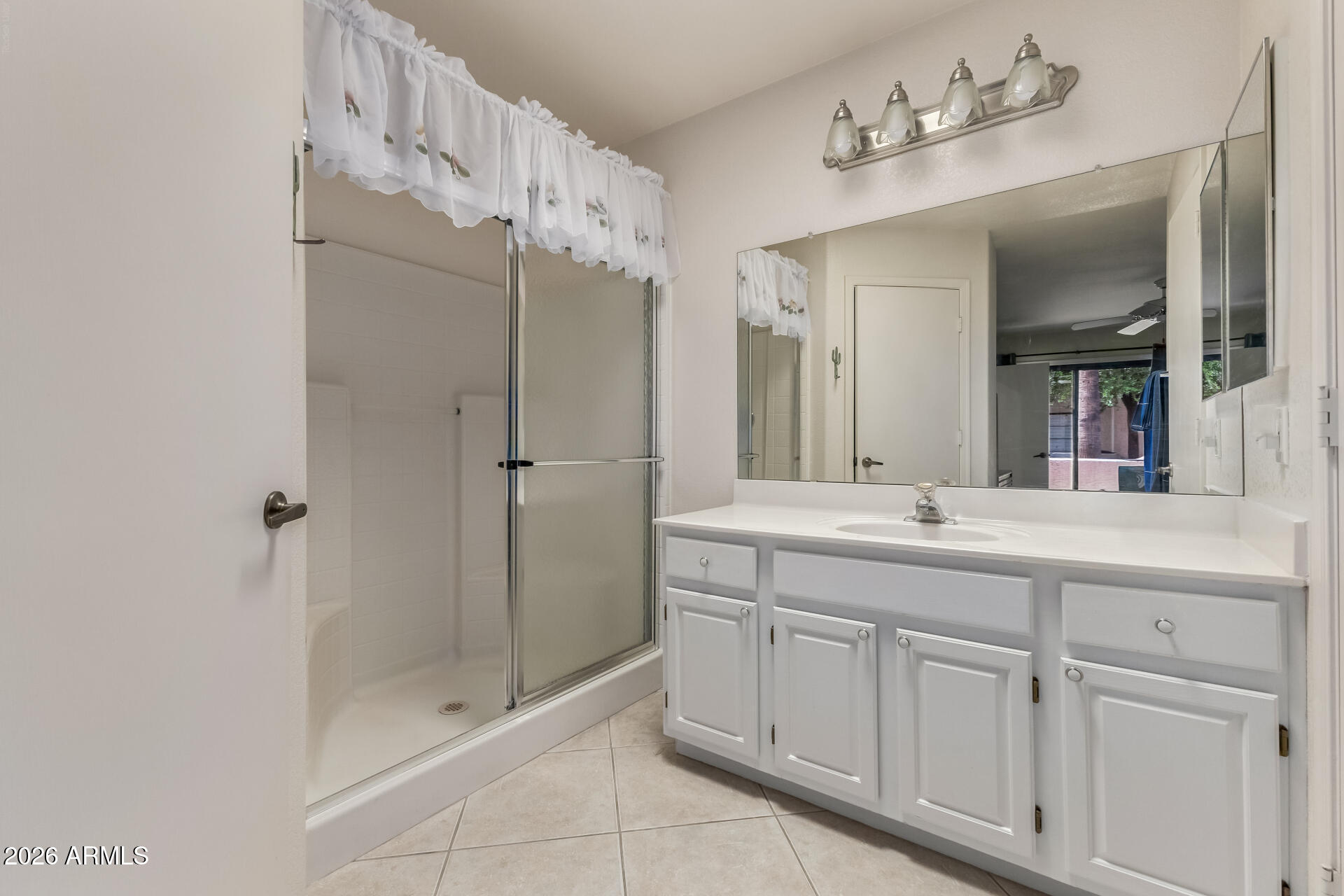 14300 West Bell Road, Unit 311 Surprise, AZ 85374 - Photo 14 of 50 a bathroom with a double vanity sink mirror and shower