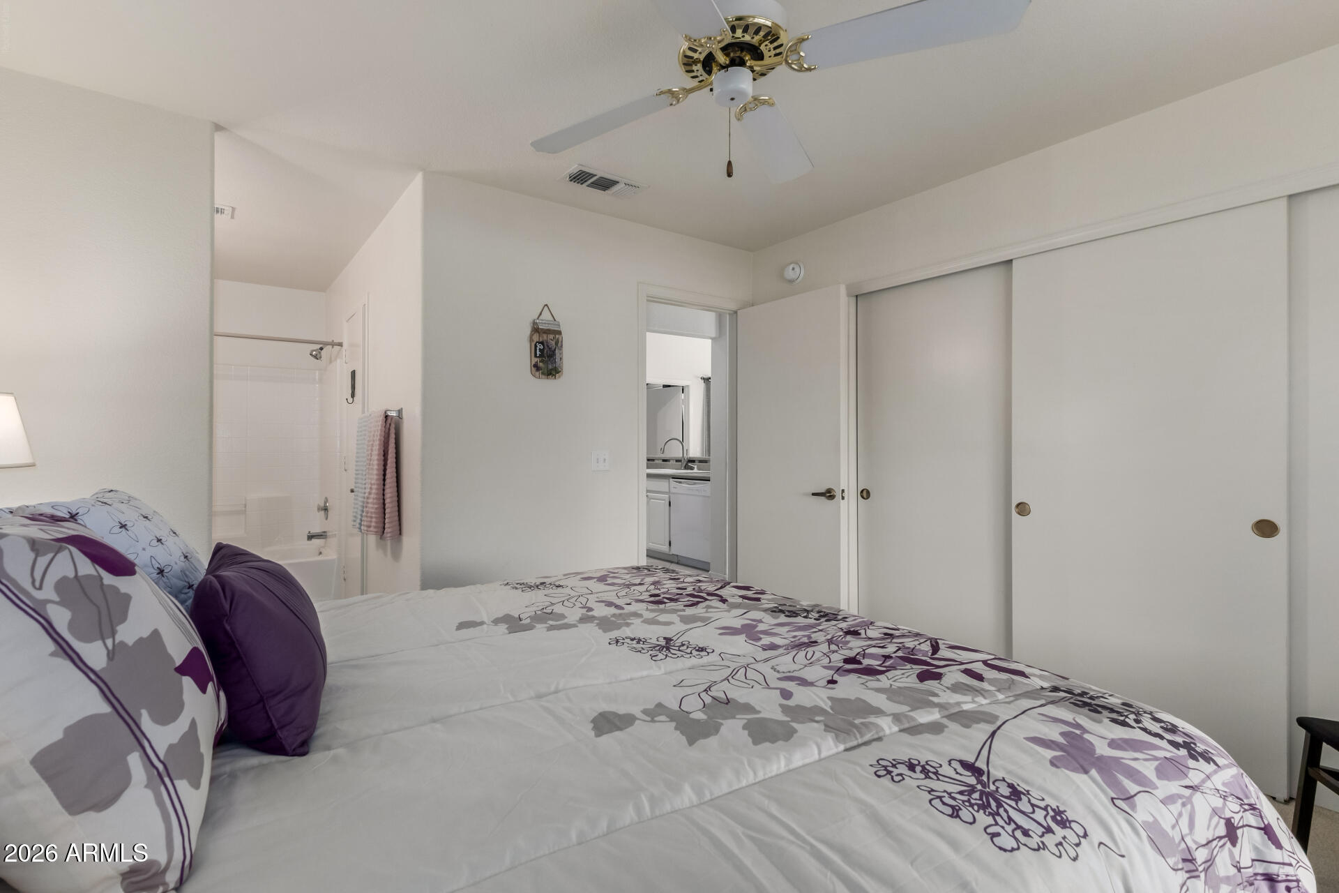 14300 West Bell Road, Unit 311 Surprise, AZ 85374 - Photo 17 of 50 a bedroom with a bed and a chandelier