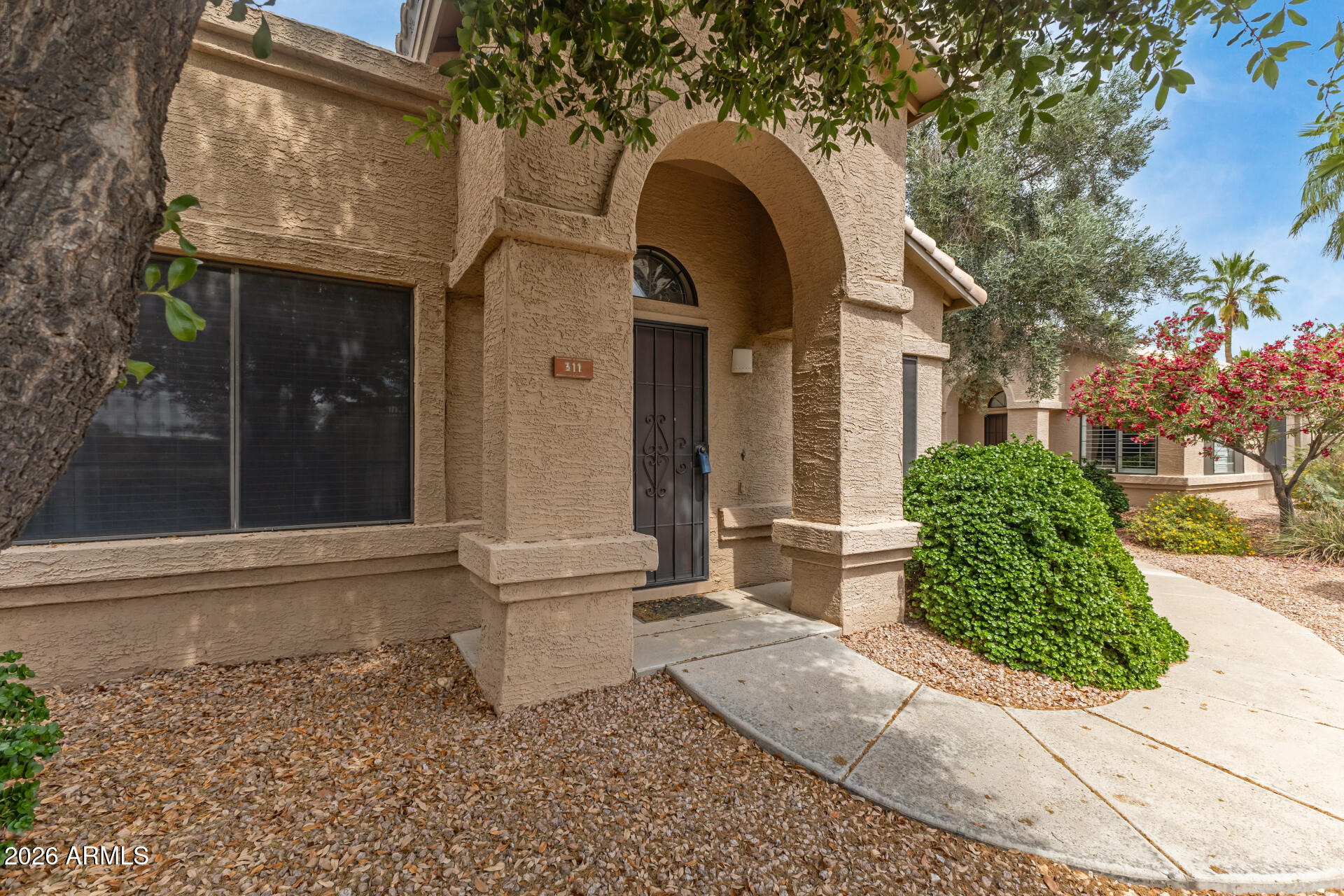 14300 West Bell Road, Unit 311 Surprise, AZ 85374 - Photo 2 of 50 a front view of a house with garden