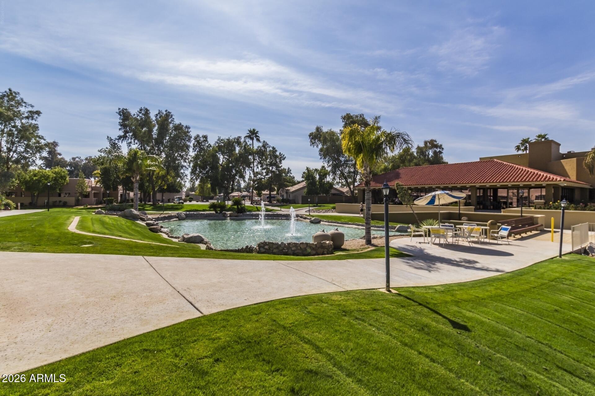 14300 West Bell Road, Unit 311 Surprise, AZ 85374 - Photo 24 of 50 a view of a house with swimming pool and a yard