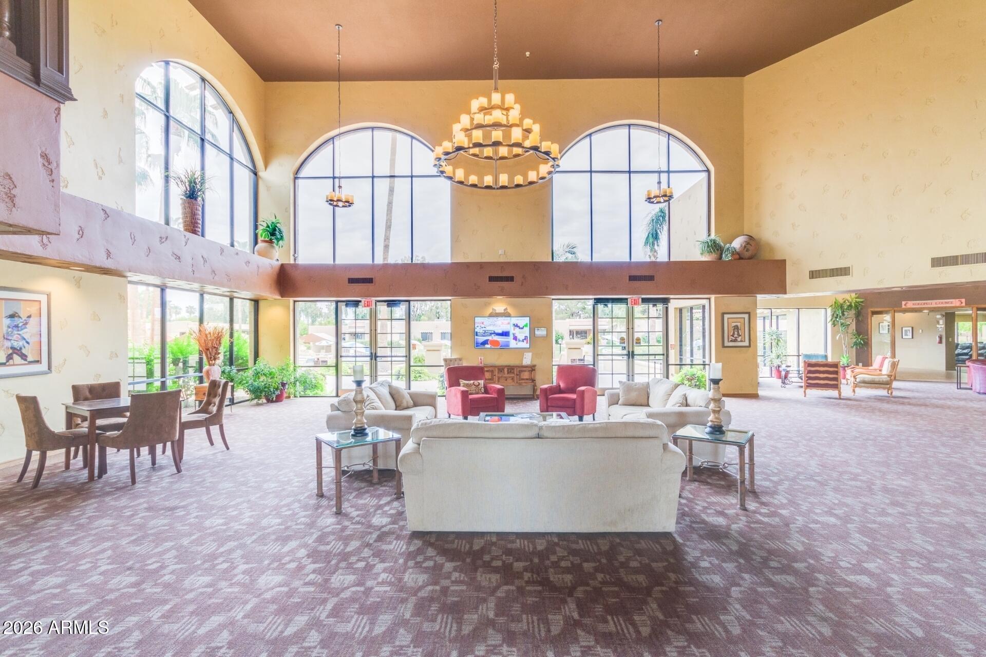 14300 West Bell Road, Unit 311 Surprise, AZ 85374 - Photo 26 of 50 a living room with fireplace furniture and a large window