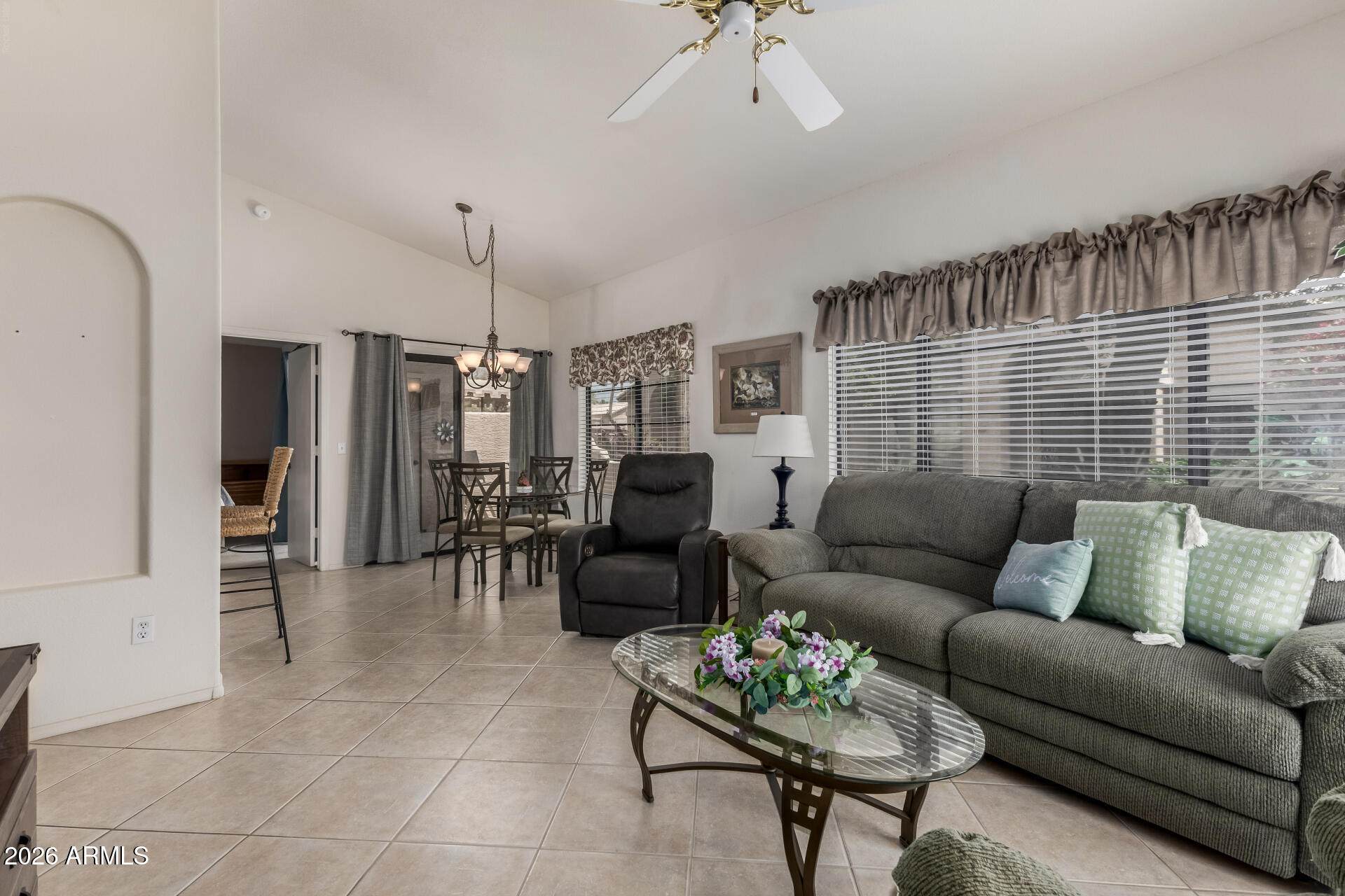 14300 West Bell Road, Unit 311 Surprise, AZ 85374 - Photo 4 of 50 a living room with furniture and a chandelier