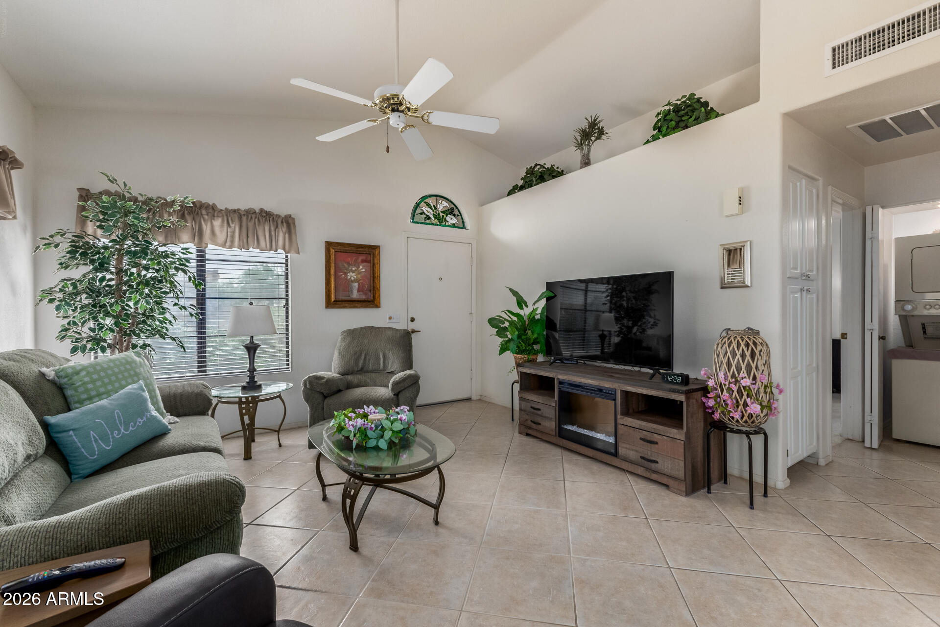 14300 West Bell Road, Unit 311 Surprise, AZ 85374 - Photo 5 of 50 a living room with furniture and a flat screen tv