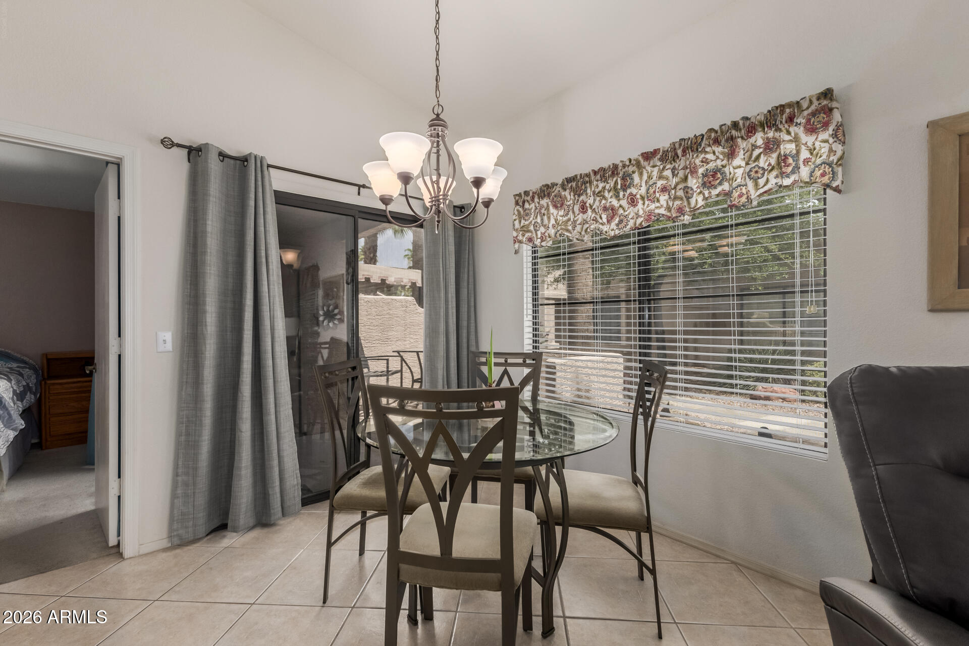 14300 West Bell Road, Unit 311 Surprise, AZ 85374 - Photo 7 of 50 a view of a dining room with furniture and chandelier