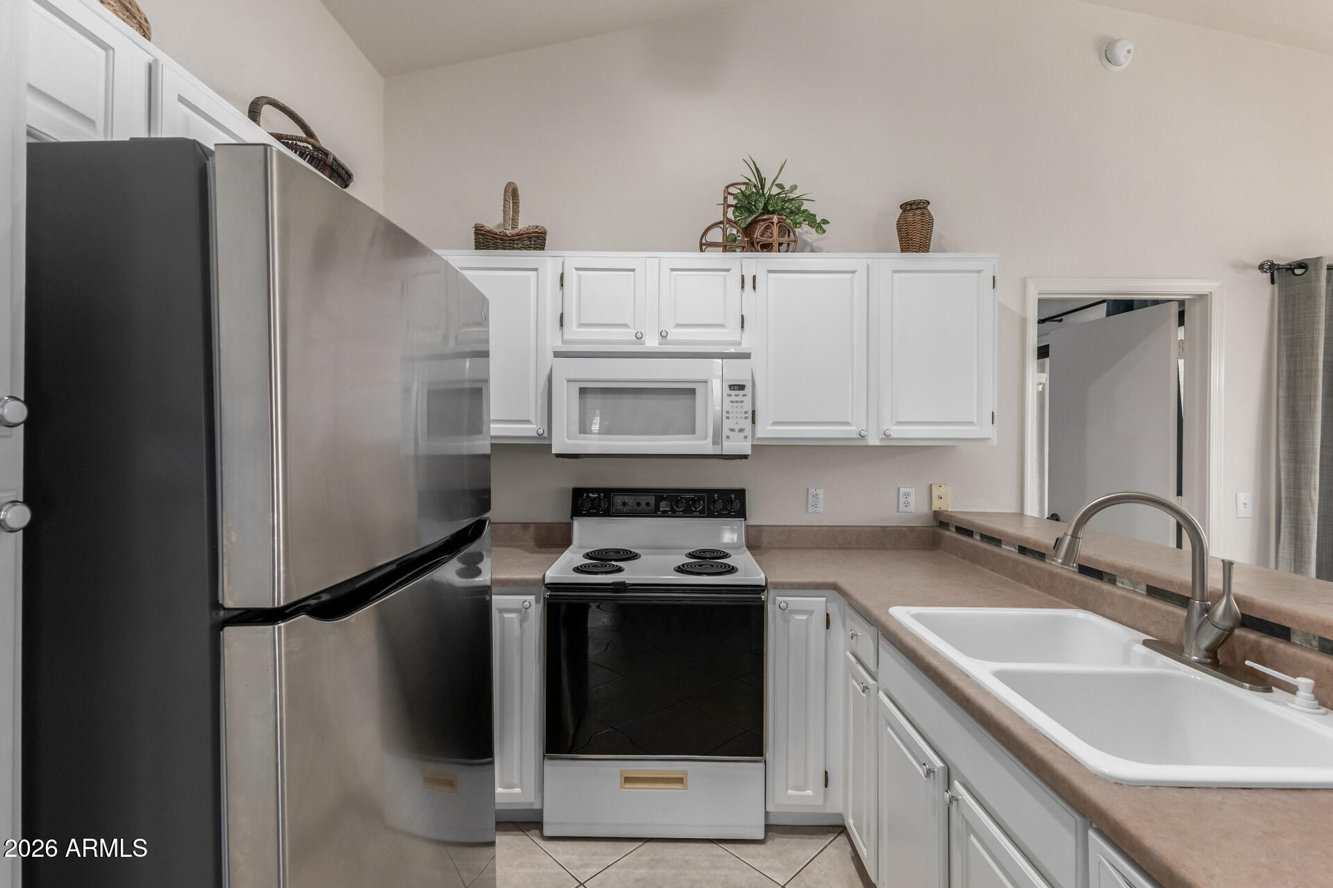 14300 West Bell Road, Unit 311 Surprise, AZ 85374 - Photo 8 of 50 a kitchen with granite countertop a refrigerator stove and sink