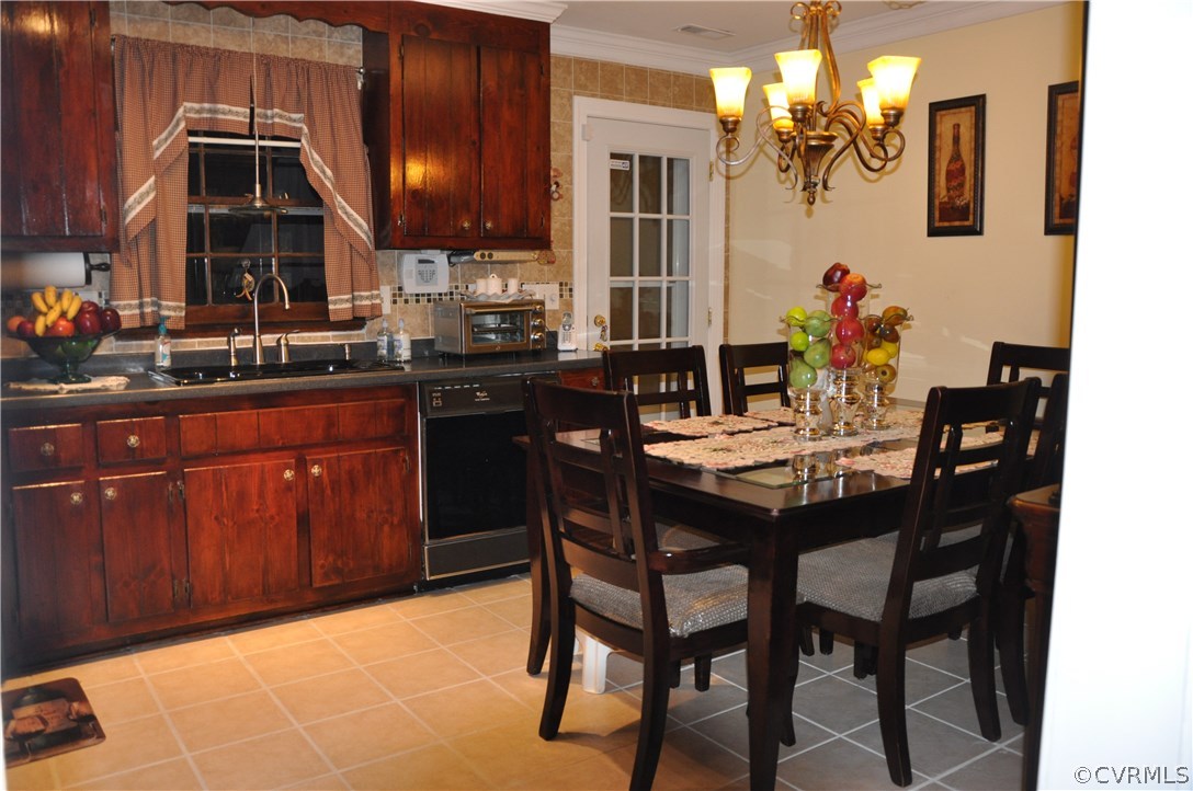 4712 Newbys Bridge Road Chesterfield, VA 23832 - Photo 3 of 17 a dining room with granite countertop a table chairs and kitchen view