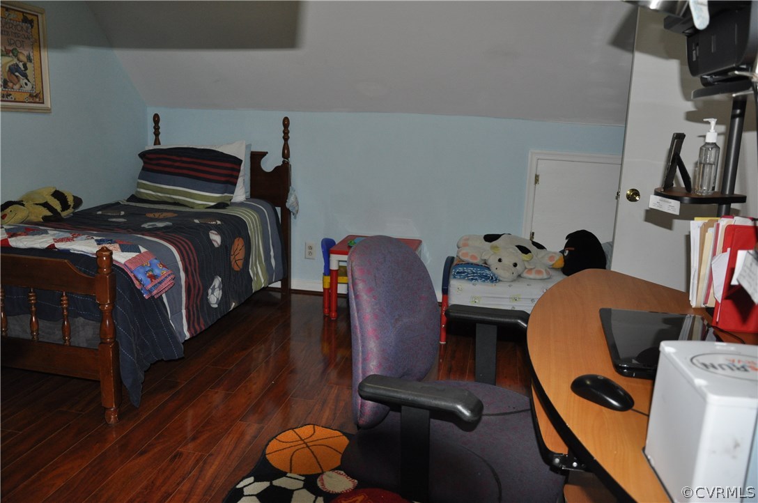 4712 Newbys Bridge Road Chesterfield, VA 23832 - Photo 8 of 17 a bedroom with a bed and wooden floor
