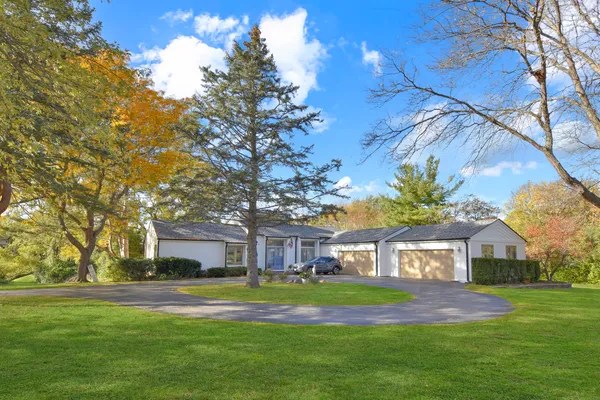 a front view of a house with a yard table and chairs