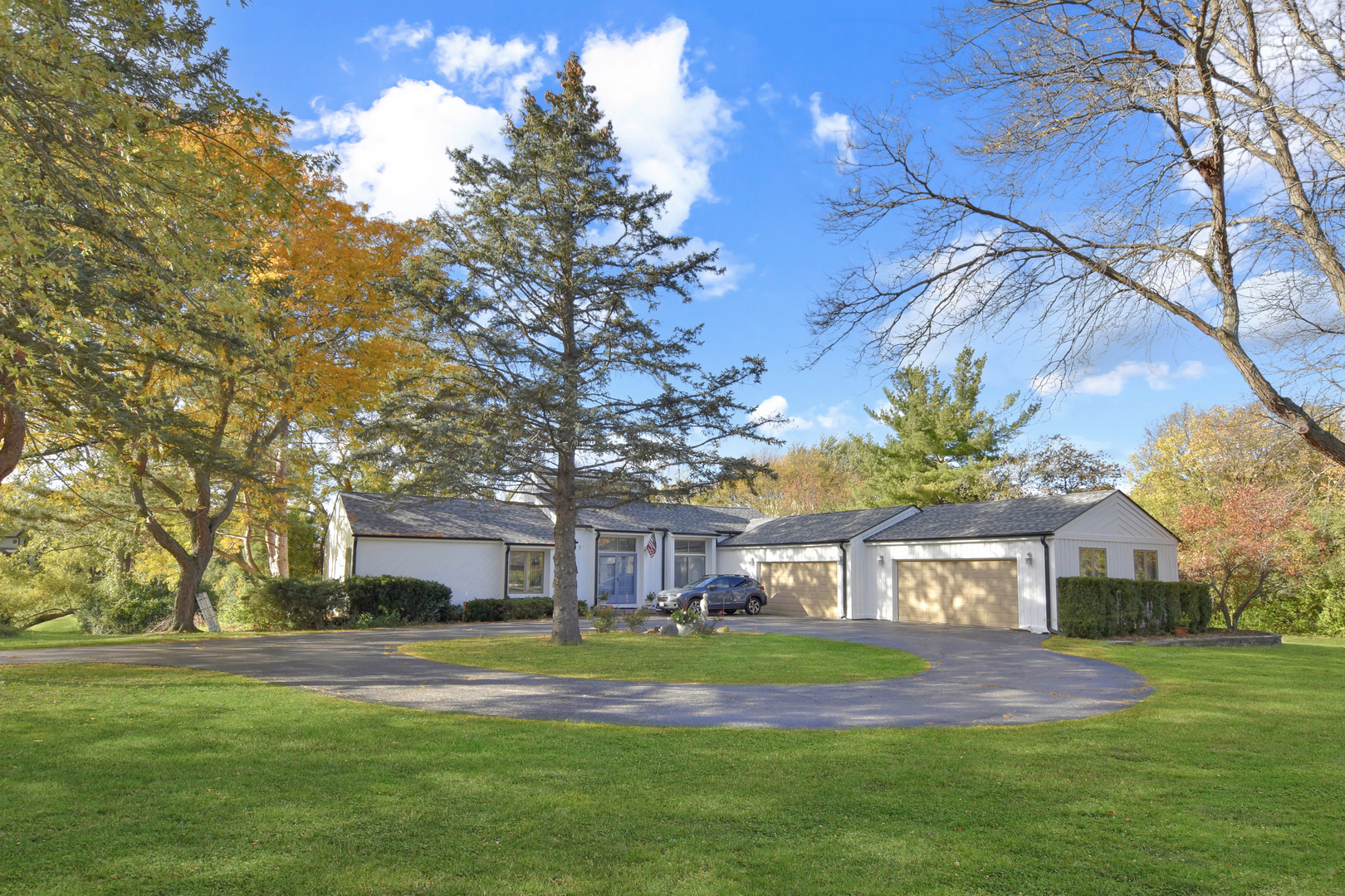 a front view of a house with a yard table and chairs