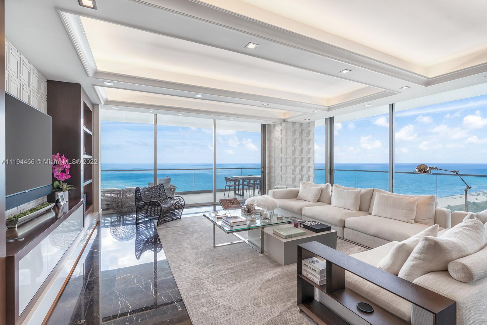 10201 Collins Avenue, Unit 1701 Bal Harbour, FL 33154 - Photo 1 of 44 a living room with furniture and a flat screen tv