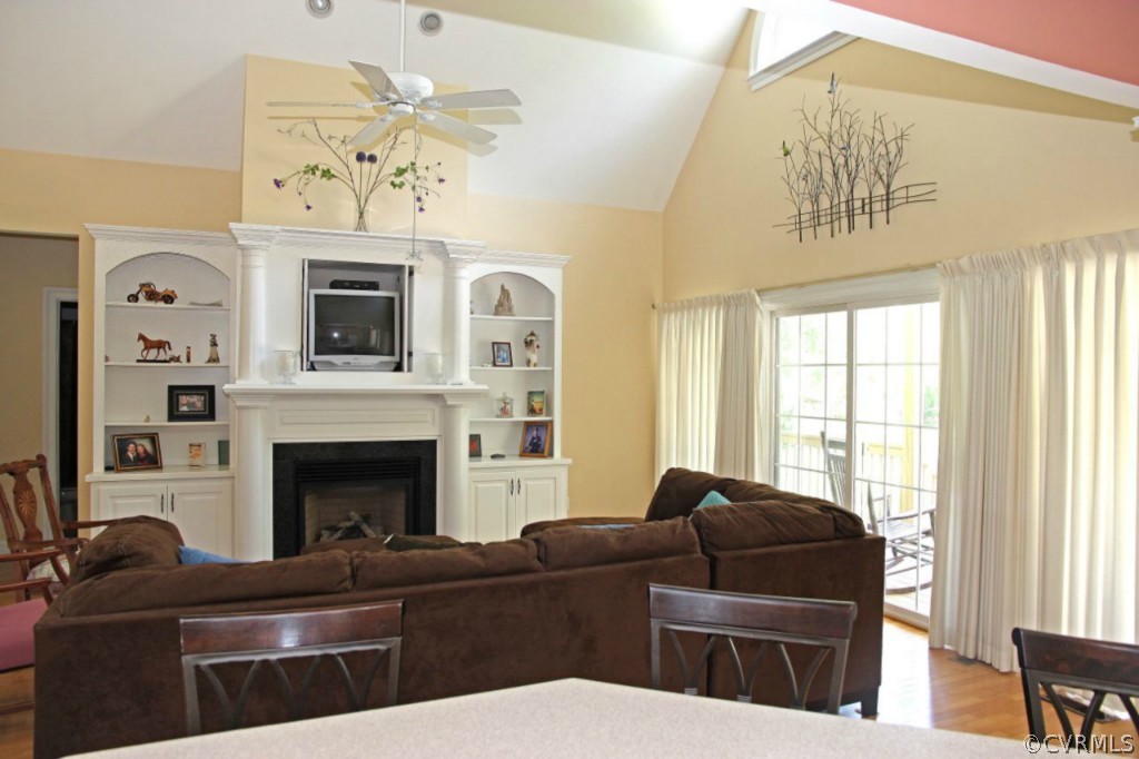 14900 Beach Road Chesterfield, VA 23838 - Photo 12 of 19 a living room with furniture a chandelier and a fireplace