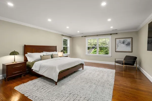 a spacious bedroom with a bed a couch and a window