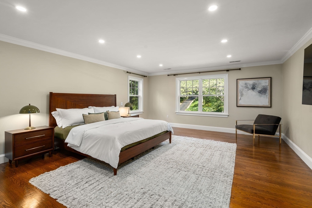 21 Westerly Road Weston, MA 02493 - Photo 16 of 38 a spacious bedroom with a bed a couch and a window